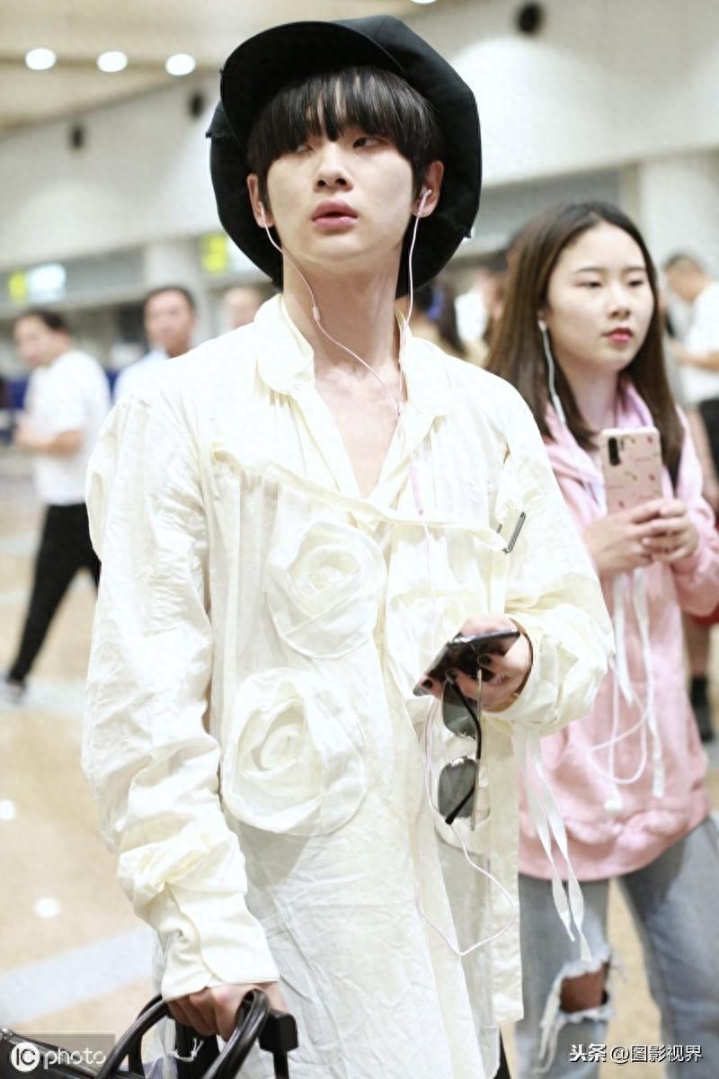 男歌手周震南现身机场,穿白衣服戴贝雷帽,涂黑色指甲油个性十足